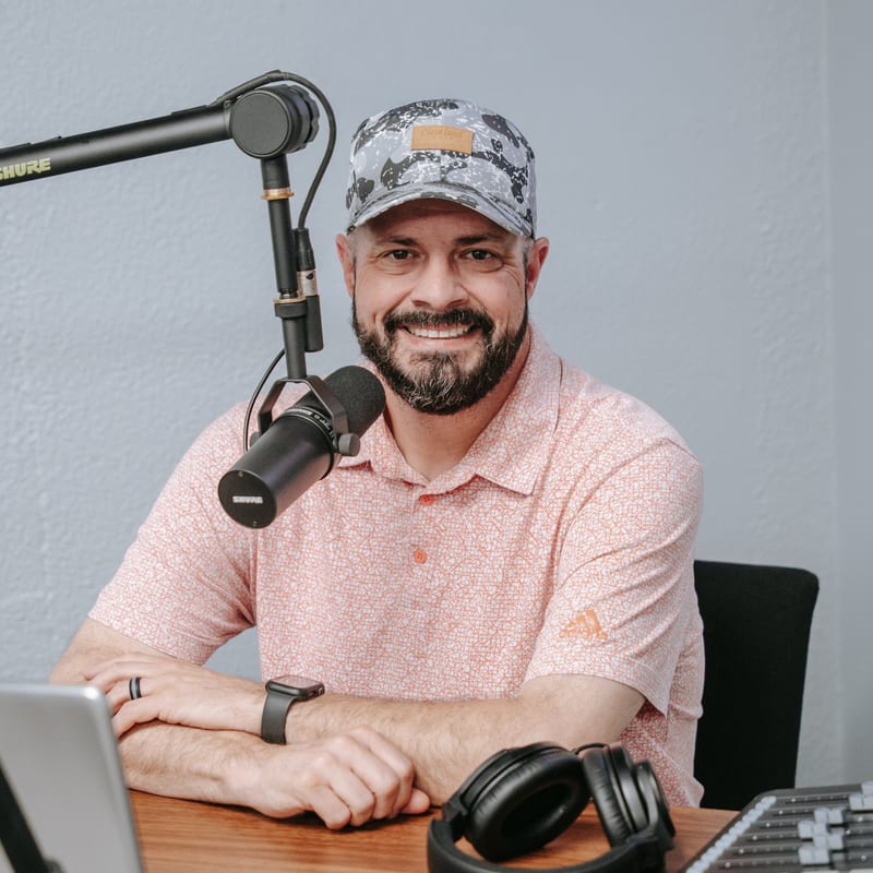 Pastor Todd at the studio desk, smiling